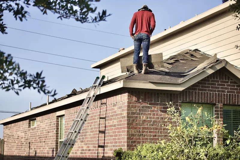 Professional roofer working on a residential roof in Hatchville